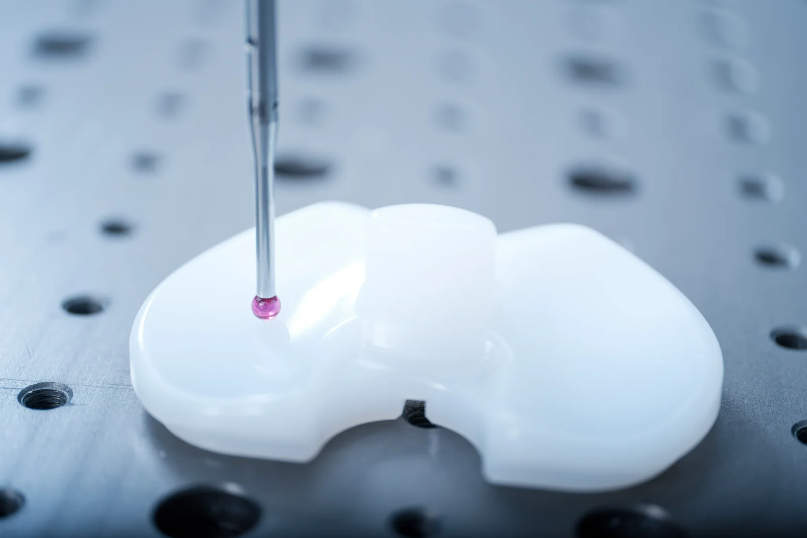 Ruby stylus measuring a moulded plastic part on the surface plate