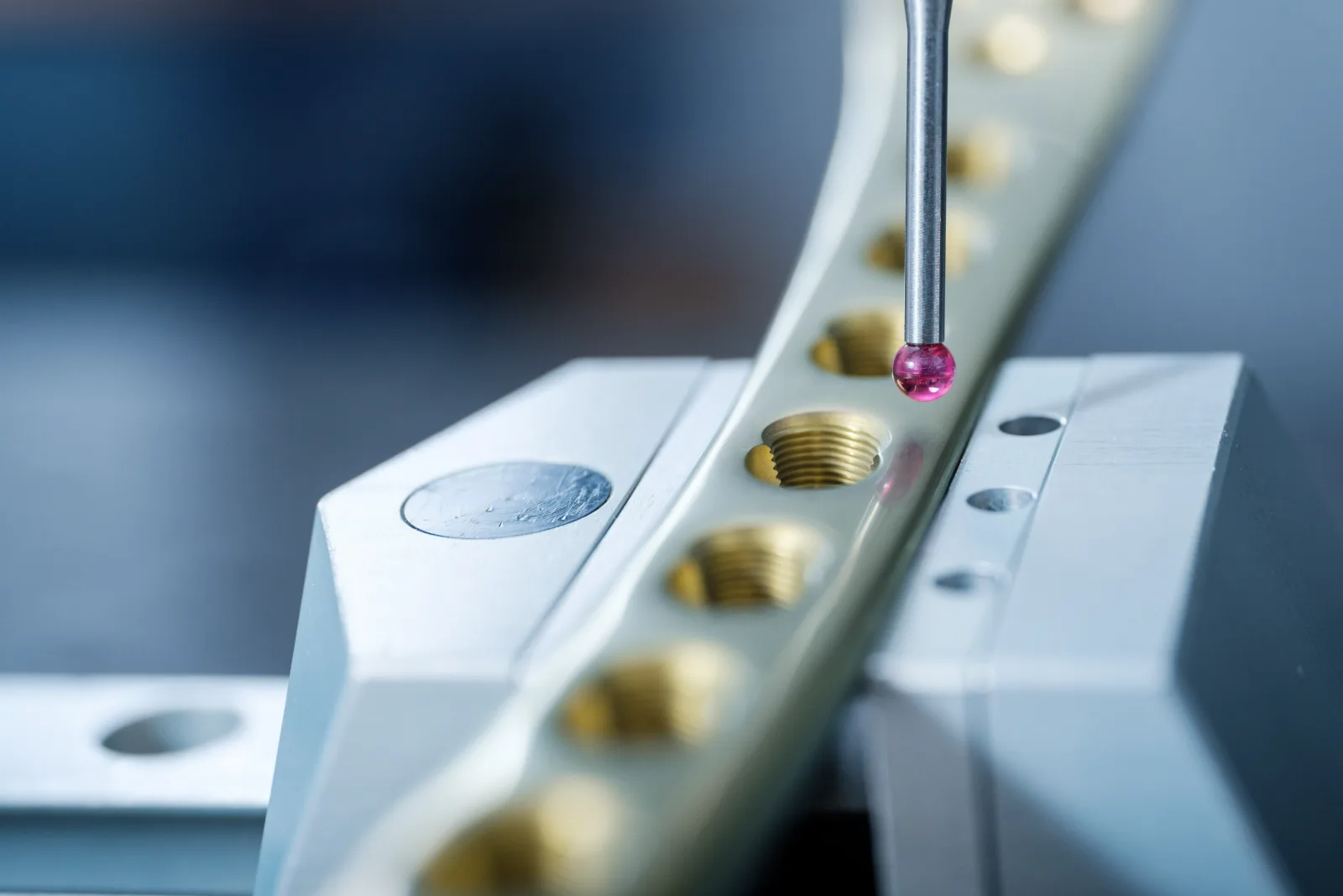 Tactile measurement: ruby stylus probing threaded holes on an elongated part
